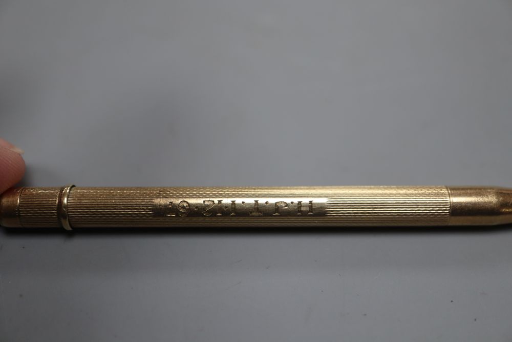 A 9ct gold cased propelling pencil, 87mm and a 9ct gold pendant( 3.2 grams).